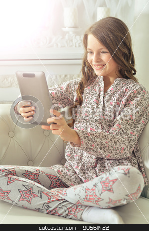 To use this stock image in your creative project, please select the size you need over to the right and click the "Add to Cart" button.
Your downloaded image will come with the Cutcaster watermark removed so don’t worry about the watermark you see on this page. Little girl using tablet stock photo, Little girl in pajama using digital tablet by Ruslan Huzau