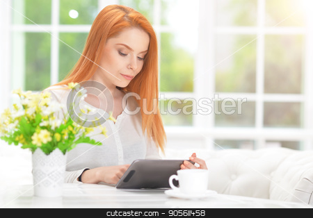 To use this stock image in your creative project, please select the size you need over to the right and click the "Add to Cart" button.
Your downloaded image will come with the Cutcaster watermark removed so don’t worry about the watermark you see on this page. woman using digital tablet stock photo, Portrait of a beautiful young woman using digital tablet by Ruslan Huzau
