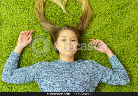 To use this stock image in your creative project, please select the size you need over to the right and click the "Add to Cart" button.
Your downloaded image will come with the Cutcaster watermark removed so don’t worry about the watermark you see on this page. Teen girl lies on the carpet stock photo, Pretty teen girl lies on the carpet by Ruslan Huzau