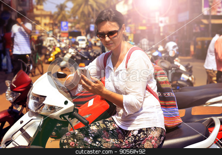 To use this stock image in your creative project, please select the size you need over to the right and click the "Add to Cart" button.
Your downloaded image will come with the Cutcaster watermark removed so don’t worry about the watermark you see on this page. Woman in sunglasses sitting on motorcycle stock photo, Woman in sunglasses sitting on motorcycle and looking in smartphone by Ruslan Huzau