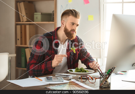 To use this stock image in your creative project, please select the size you need over to the right and click the "Add to Cart" button.
Your downloaded image will come with the Cutcaster watermark removed so don’t worry about the watermark you see on this page. Young man architect working in the office ocuupation stock photo, Young male architect working indoors eating lunch by Dmytro Sidelnikov