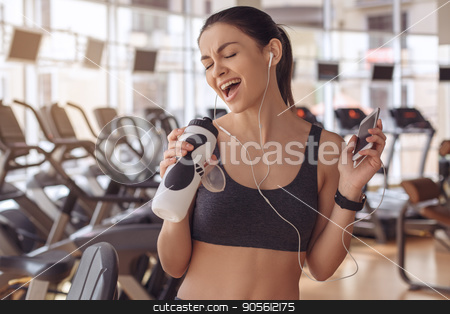 To use this stock image in your creative project, please select the size you need over to the right and click the "Add to Cart" button.
Your downloaded image will come with the Cutcaster watermark removed so don’t worry about the watermark you see on this page. Young woman workout in gym healthy lifestyle stock photo, Young female training in gym healthy lifestyle listening music by Dmytro Sidelnikov