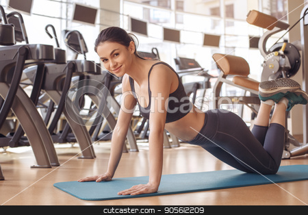 To use this stock image in your creative project, please select the size you need over to the right and click the "Add to Cart" button.
Your downloaded image will come with the Cutcaster watermark removed so don’t worry about the watermark you see on this page. Young woman workout in gym healthy lifestyle stock photo, Young female training in gym healthy lifestyle exercise on yoga mat by Dmytro Sidelnikov