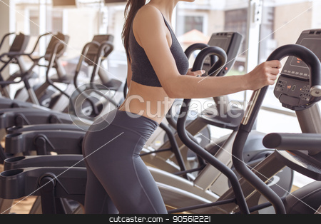 To use this stock image in your creative project, please select the size you need over to the right and click the "Add to Cart" button.
Your downloaded image will come with the Cutcaster watermark removed so don’t worry about the watermark you see on this page. Young woman workout in gym healthy lifestyle stock photo, Young female training in gym healthy lifestyle elliptical trainer by Dmytro Sidelnikov
