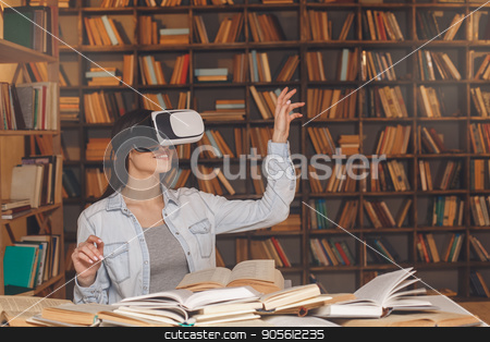 To use this stock image in your creative project, please select the size you need over to the right and click the "Add to Cart" button.
Your downloaded image will come with the Cutcaster watermark removed so don’t worry about the watermark you see on this page. Young woman study in the library alone stock photo, Young female study in the library using virtual reality headset by Dmytro Sidelnikov