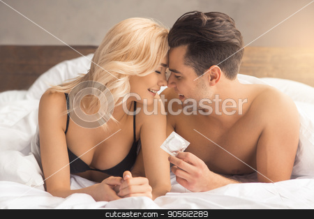 To use this stock image in your creative project, please select the size you need over to the right and click the "Add to Cart" button.
Your downloaded image will come with the Cutcaster watermark removed so don’t worry about the watermark you see on this page. Young couple intimate relationship on bed passion stock photo, Young couple man and woman intimate relationship on bed kissing by Dmytro Sidelnikov