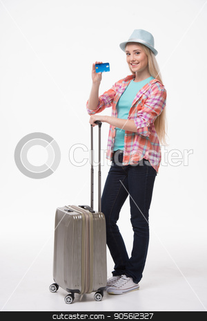 To use this stock image in your creative project, please select the size you need over to the right and click the "Add to Cart" button.
Your downloaded image will come with the Cutcaster watermark removed so don’t worry about the watermark you see on this page. Beautiful young woman on white background stock photo, Travel concept. Portrait of stylish beautiful young woman isolated on white background. Woman with suitcase smiling, looking at camera and showing credit card by Dmytro Sidelnikov