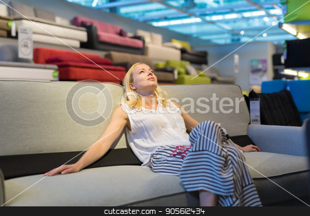 To use this stock image in your creative project, please select the size you need over to the right and click the "Add to Cart" button.
Your downloaded image will come with the Cutcaster watermark removed so don’t worry about the watermark you see on this page. Woman shopping for furniture, sofa and home decor in store stock photo, Caucasian woman shopping for furniture, sofa and home decor in store. Lady sitting on couch imagining her new home architectural arrangement. by kasto