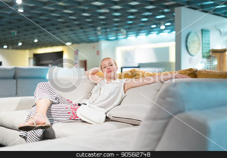 To use this stock image in your creative project, please select the size you need over to the right and click the "Add to Cart" button.
Your downloaded image will come with the Cutcaster watermark removed so don’t worry about the watermark you see on this page. Woman shopping for furniture, sofa and home decor in store stock photo, Caucasian woman shopping for furniture, sofa and home decor in store. Lady sitting on couch imagining her new home architectural arrangement. by kasto