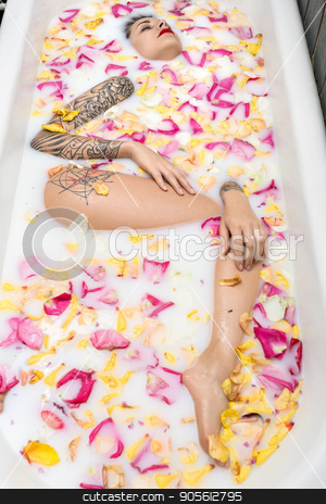 To use this stock image in your creative project, please select the size you need over to the right and click the "Add to Cart" button.
Your downloaded image will come with the Cutcaster watermark removed so don’t worry about the watermark you see on this page. Charming girl with fancy tattoos lies in the white bath full of stock photo, Charming girl with fancy tattoos lies in the white bath full of water with milk and colorful flower petals. Her eyes are closed. Top view photo. Indoors. Vertical by bezikus
