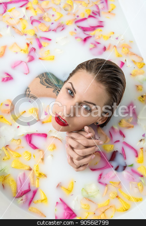 To use this stock image in your creative project, please select the size you need over to the right and click the "Add to Cart" button.
Your downloaded image will come with the Cutcaster watermark removed so don’t worry about the watermark you see on this page. Tattooed girl relaxing in bath stock photo, Charming girl with wet hair and colorful tattoos in the white bath full of water with milk and flower petals. Beauty holds her hands together and looks into camera with parted lips. Top view photo by bezikus