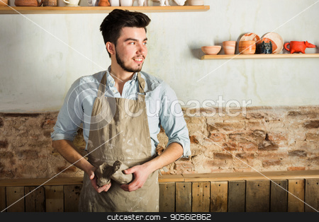 To use this stock image in your creative project, please select the size you need over to the right and click the "Add to Cart" button.
Your downloaded image will come with the Cutcaster watermark removed so don’t worry about the watermark you see on this page. potter, tools, ceramics art concept - smiling brunette man with a beard dressed in an apron, hands of young master holding the large pieces of fireclay, a ceramist with raw materials at workshop. stock photo, potter, tools, ceramics art concept - smiling brunette man with a beard dressed in an apron, hands of young master holding the large pieces of fireclay, a ceramist with raw materials at workshop by Dmitry