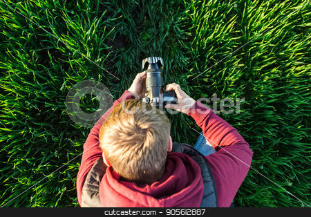 To use this stock image in your creative project, please select the size you need over to the right and click the "Add to Cart" button.
Your downloaded image will come with the Cutcaster watermark removed so don’t worry about the watermark you see on this page. fascinating photography and process of shooting concept - top view of young male man with mirror camera in hands standing in a field of bright green grass, jeans and jacket hoodie. stock photo, fascinating photography and process of shooting concept - top view of young male man with mirror camera in hands standing in a field of bright green grass, jeans and jacket hoodie by Dmitry