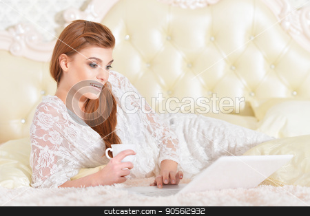 To use this stock image in your creative project, please select the size you need over to the right and click the "Add to Cart" button.
Your downloaded image will come with the Cutcaster watermark removed so don’t worry about the watermark you see on this page. young woman with laptop stock photo, Beautiful young woman on bed with laptop by Ruslan Huzau