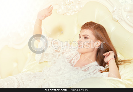To use this stock image in your creative project, please select the size you need over to the right and click the "Add to Cart" button.
Your downloaded image will come with the Cutcaster watermark removed so don’t worry about the watermark you see on this page. beautiful young woman stock photo, beautiful young woman in white blouse posing on vintage bed by Ruslan Huzau