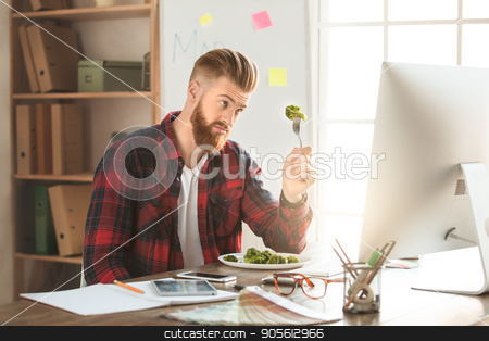 To use this stock image in your creative project, please select the size you need over to the right and click the "Add to Cart" button.
Your downloaded image will come with the Cutcaster watermark removed so don’t worry about the watermark you see on this page. Young man architect working in the office ocuupation stock photo, Young male architect working indoors eating lunch by Dmytro Sidelnikov