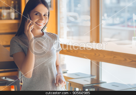 To use this stock image in your creative project, please select the size you need over to the right and click the "Add to Cart" button.
Your downloaded image will come with the Cutcaster watermark removed so don’t worry about the watermark you see on this page. Young woman standing in a coffee shop leisure stock photo, Young female standing in a cafe indoors rest using digital device by Dmytro Sidelnikov