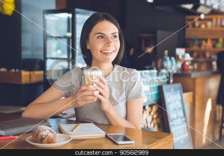 To use this stock image in your creative project, please select the size you need over to the right and click the "Add to Cart" button.
Your downloaded image will come with the Cutcaster watermark removed so don’t worry about the watermark you see on this page. Young woman sitting in a coffee shop leisure stock photo, Young female sitting in a cafe indoors rest drinking coffee by Dmytro Sidelnikov