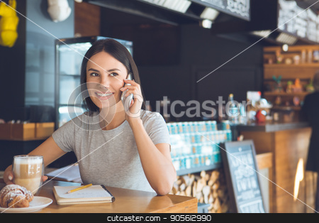 To use this stock image in your creative project, please select the size you need over to the right and click the "Add to Cart" button.
Your downloaded image will come with the Cutcaster watermark removed so don’t worry about the watermark you see on this page. Young woman sitting in a coffee shop leisure stock photo, Young female sitting in a cafe indoors rest using digital device by Dmytro Sidelnikov