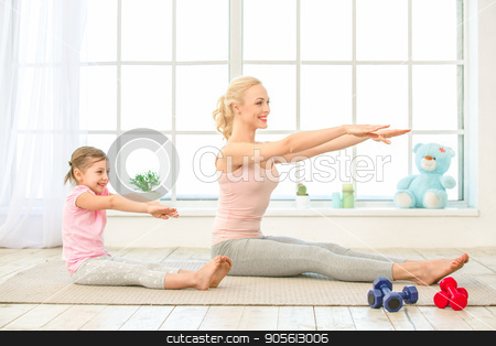 To use this stock image in your creative project, please select the size you need over to the right and click the "Add to Cart" button.
Your downloaded image will come with the Cutcaster watermark removed so don’t worry about the watermark you see on this page. Young mother and daughter exercise together indoors stock photo, Young mother and little daughter exercise together in the morning at home by Dmytro Sidelnikov