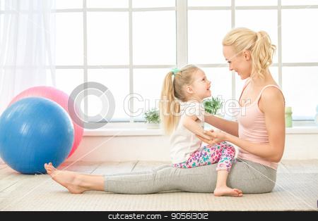 To use this stock image in your creative project, please select the size you need over to the right and click the "Add to Cart" button.
Your downloaded image will come with the Cutcaster watermark removed so don’t worry about the watermark you see on this page. Young mother and daughter exercise together indoors stock photo, Young mother and little daughter exercise together in the morning at home by Dmytro Sidelnikov