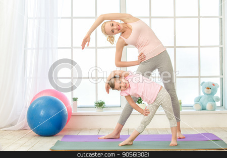 To use this stock image in your creative project, please select the size you need over to the right and click the "Add to Cart" button.
Your downloaded image will come with the Cutcaster watermark removed so don’t worry about the watermark you see on this page. Young mother and daughter exercise together indoors stock photo, Young mother and little daughter exercise together in the morning at home by Dmytro Sidelnikov