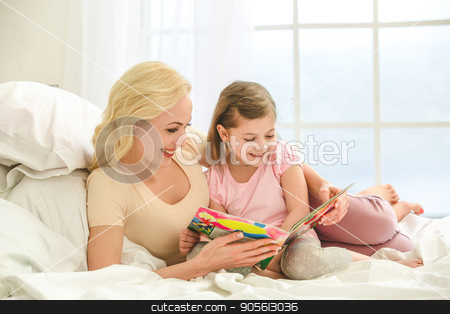 To use this stock image in your creative project, please select the size you need over to the right and click the "Add to Cart" button.
Your downloaded image will come with the Cutcaster watermark removed so don’t worry about the watermark you see on this page. Young mother and daughter morning on bed indoors stock photo, Young mother and daughter morning on bed at home reading book by Dmytro Sidelnikov