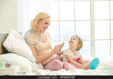 To use this stock image in your creative project, please select the size you need over to the right and click the "Add to Cart" button.
Your downloaded image will come with the Cutcaster watermark removed so don’t worry about the watermark you see on this page. Young mother and daughter morning on bed indoors stock photo, Young mother and daughter morning on bed at home making hairstyle by Dmytro Sidelnikov