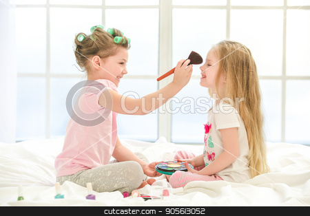 To use this stock image in your creative project, please select the size you need over to the right and click the "Add to Cart" button.
Your downloaded image will come with the Cutcaster watermark removed so don’t worry about the watermark you see on this page. Little kids girls sisters doing makeup indoors stock photo, Little children girls sisters playing doing makeup on bed at home by Dmytro Sidelnikov