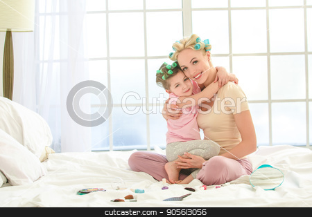 To use this stock image in your creative project, please select the size you need over to the right and click the "Add to Cart" button.
Your downloaded image will come with the Cutcaster watermark removed so don’t worry about the watermark you see on this page. Young mother and daughter morning on bed indoors stock photo, Young mother and daughter morning on bed at home makeup by Dmytro Sidelnikov