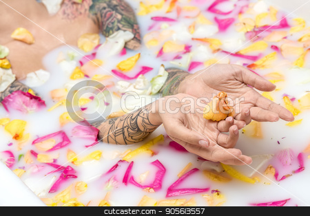 To use this stock image in your creative project, please select the size you need over to the right and click the "Add to Cart" button.
Your downloaded image will come with the Cutcaster watermark removed so don’t worry about the watermark you see on this page. Tattooed girl relaxing in bath stock photo, Cute girl with colorful tattoos lies in the water with milk and flower petals. She holds some petals on her palms. Closeup. Indoors. Horizontal by bezikus
