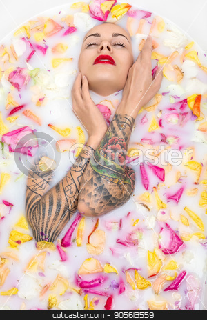 To use this stock image in your creative project, please select the size you need over to the right and click the "Add to Cart" button.
Your downloaded image will come with the Cutcaster watermark removed so don’t worry about the watermark you see on this page. Tattooed girl posing in bath stock photo, Charming girl with closed eyes and parted lips lies in the bath full of water with milk and colorful flower petals. She has colorful tattoos on her arms. Top view photo. Indoors. Vertical by bezikus