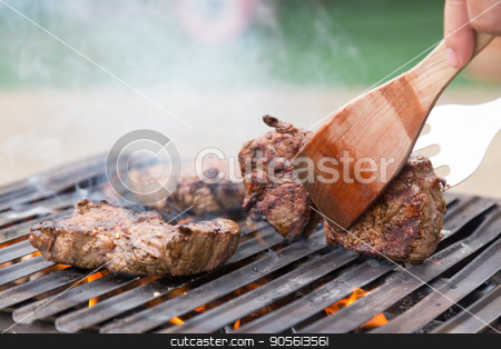 To use this stock image in your creative project, please select the size you need over to the right and click the "Add to Cart" button.
Your downloaded image will come with the Cutcaster watermark removed so don’t worry about the watermark you see on this page. Chef grilling beef steaks on open flame BBQ. stock photo, Chef grilling a beef steak on open flame BBQ. by kasto