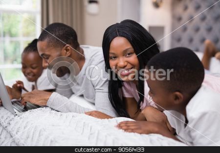 To use this stock image in your creative project, please select the size you need over to the right and click the "Add to Cart" button.
Your downloaded image will come with the Cutcaster watermark removed so don’t worry about the watermark you see on this page. Portrait of smiling woman lying with family on bed stock photo, Portrait of smiling woman lying with family on bed at home by Wavebreak Media
