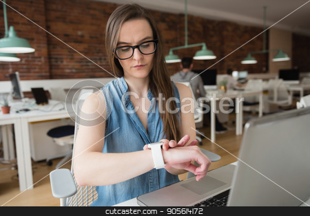 To use this stock image in your creative project, please select the size you need over to the right and click the "Add to Cart" button.
Your downloaded image will come with the Cutcaster watermark removed so don’t worry about the watermark you see on this page. Female executive adjusting smart watch at desk stock photo, Female executive adjusting smart watch at desk in office by Wavebreak Media