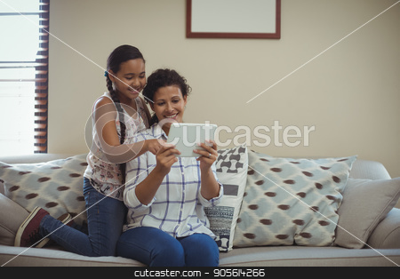 To use this stock image in your creative project, please select the size you need over to the right and click the "Add to Cart" button.
Your downloaded image will come with the Cutcaster watermark removed so don’t worry about the watermark you see on this page. Mother and daughter using digital tablet in living room stock photo, Mother and daughter using digital tablet in living room at home by Wavebreak Media
