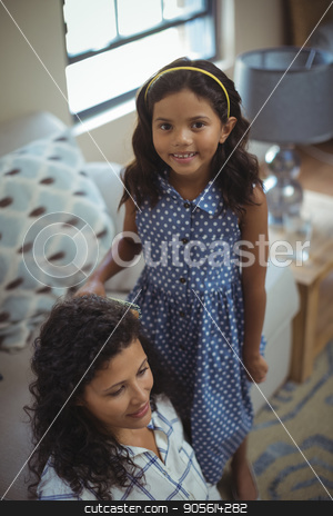 To use this stock image in your creative project, please select the size you need over to the right and click the "Add to Cart" button.
Your downloaded image will come with the Cutcaster watermark removed so don’t worry about the watermark you see on this page. Cute daughter combing mothers hair in living room stock photo, Cute daughter combing mothers hair in living room at home by Wavebreak Media