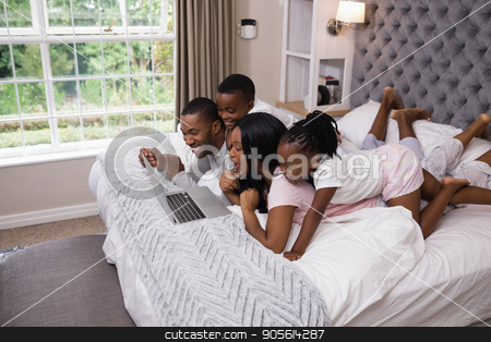 To use this stock image in your creative project, please select the size you need over to the right and click the "Add to Cart" button.
Your downloaded image will come with the Cutcaster watermark removed so don’t worry about the watermark you see on this page. Happy family shopping online while lying on bed stock photo, Happy family shopping online while lying on bed at home by Wavebreak Media