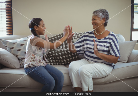 To use this stock image in your creative project, please select the size you need over to the right and click the "Add to Cart" button.
Your downloaded image will come with the Cutcaster watermark removed so don’t worry about the watermark you see on this page. Grandmother and granddaughter having fun in living room stock photo, Grandmother and granddaughter having fun in living room at home by Wavebreak Media
