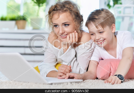 To use this stock image in your creative project, please select the size you need over to the right and click the "Add to Cart" button.
Your downloaded image will come with the Cutcaster watermark removed so don’t worry about the watermark you see on this page. Mother and son looking at modern laptop stock photo, Mother and son lying on floor and looking at modern laptop by Ruslan Huzau