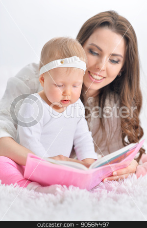To use this stock image in your creative project, please select the size you need over to the right and click the "Add to Cart" button.
Your downloaded image will come with the Cutcaster watermark removed so don’t worry about the watermark you see on this page. Beautiful young mother with daughter reading book stock photo, Beautiful young mother with cute little daughter reading book by Ruslan Huzau