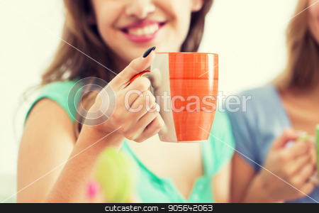To use this stock image in your creative project, please select the size you need over to the right and click the "Add to Cart" button.
Your downloaded image will come with the Cutcaster watermark removed so don’t worry about the watermark you see on this page. happy woman or teen girl drinking tea from cup stock photo, people and drinks concept - close up of happy woman or teen girl drinking tea from cup by Syda Productions