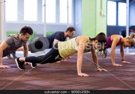 To use this stock image in your creative project, please select the size you need over to the right and click the "Add to Cart" button.
Your downloaded image will come with the Cutcaster watermark removed so don’t worry about the watermark you see on this page. group of people exercising in gym stock photo, fitness, sport, exercising, training and healthy lifestyle concept - group of people doing straight arm plank in gym by Syda Productions