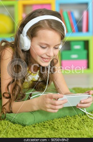 To use this stock image in your creative project, please select the size you need over to the right and click the "Add to Cart" button.
Your downloaded image will come with the Cutcaster watermark removed so don’t worry about the watermark you see on this page. Cute little girl with headphones stock photo, Cute little girl with smartphone and headphones by Ruslan Huzau