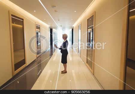 To use this stock image in your creative project, please select the size you need over to the right and click the "Add to Cart" button.
Your downloaded image will come with the Cutcaster watermark removed so don’t worry about the watermark you see on this page. Businesswoman using laptop in corridor stock photo, Businesswoman using laptop while standing in corridor by Wavebreak Media