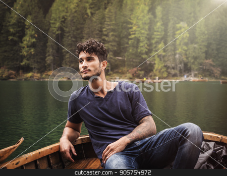 To use this stock image in your creative project, please select the size you need over to the right and click the "Add to Cart" button.
Your downloaded image will come with the Cutcaster watermark removed so don’t worry about the watermark you see on this page. Young man relaxing in boat stock photo, Handsome tattooed man sitting in boat on background of woods on shore of lake looking away. by Stefano Cavoretto