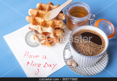 To use this stock image in your creative project, please select the size you need over to the right and click the "Add to Cart" button.
Your downloaded image will come with the Cutcaster watermark removed so don’t worry about the watermark you see on this page. Tasty breakfast and napkin message stock photo, Cup of coffee with heart shaped sugar, homemade waffles with honey and a napkin with have a nice day message, on a blue wooden table. by Daniela Simona Temneanu