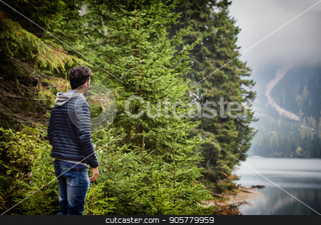 To use this stock image in your creative project, please select the size you need over to the right and click the "Add to Cart" button.
Your downloaded image will come with the Cutcaster watermark removed so don’t worry about the watermark you see on this page. Young man relaxing in the mountain stock photo, Handsome yung man standing on background of woods on shore of lake looking away. by Stefano Cavoretto