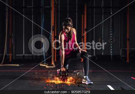 To use this stock image in your creative project, please select the size you need over to the right and click the "Add to Cart" button.
Your downloaded image will come with the Cutcaster watermark removed so don’t worry about the watermark you see on this page. Athletic girl works out at the gym with a fiery kettlebell stock photo, Determined athletic girl works out at the gym with a fiery kettlebell by Federico Caputo