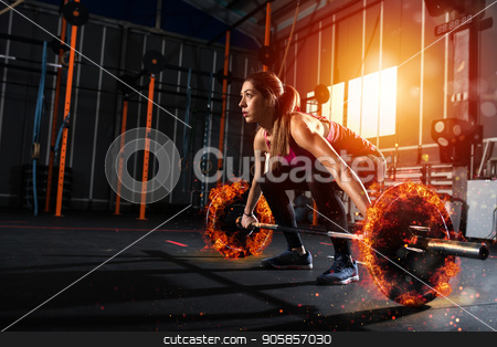 To use this stock image in your creative project, please select the size you need over to the right and click the "Add to Cart" button.
Your downloaded image will come with the Cutcaster watermark removed so don’t worry about the watermark you see on this page. Athletic girl works out at the gym with a fiery barbell stock photo, Determined athletic girl works out at the gym with a fiery barbell by Federico Caputo